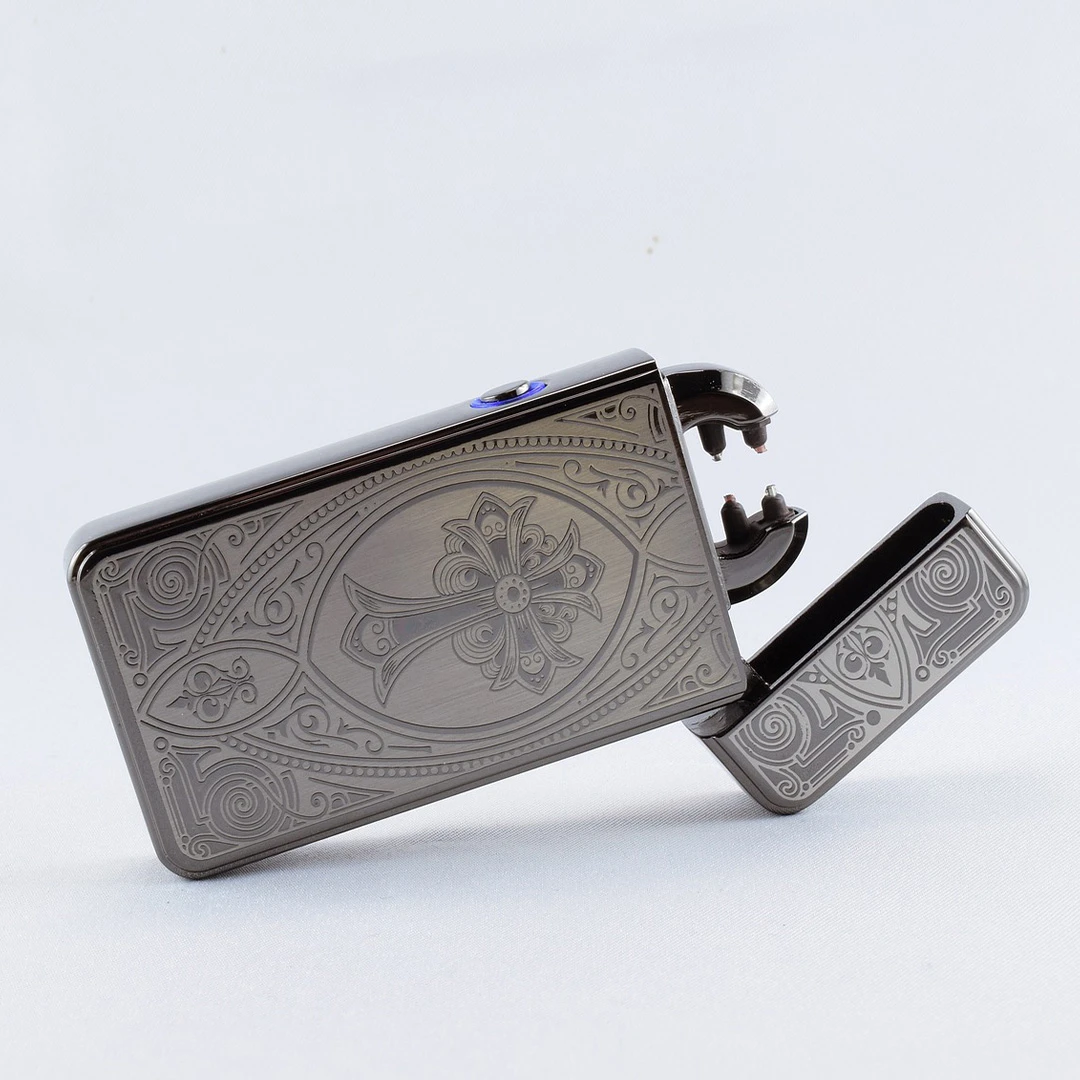 A silver lighter with a design on it.