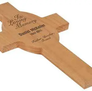 A wooden cross with the words in loving memory written on it.