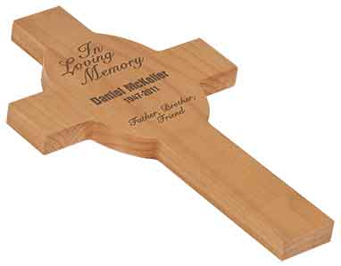 A wooden cross with the words in loving memory written on it.