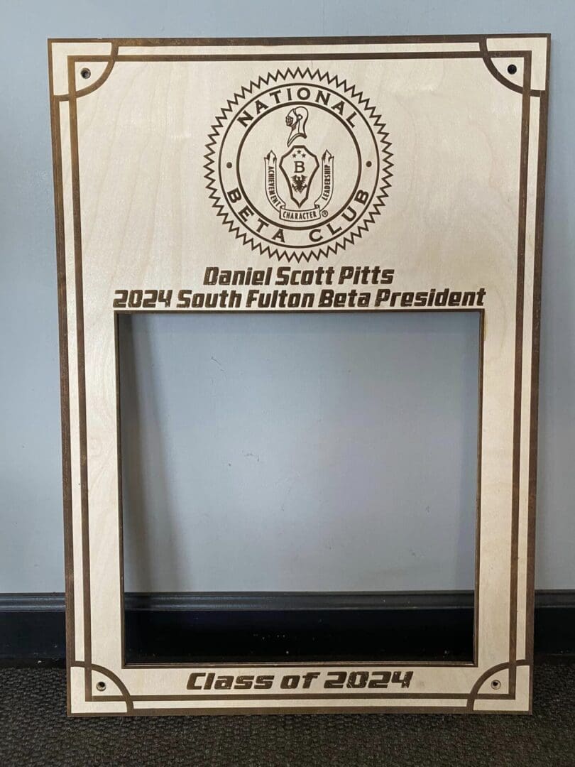 A wooden frame with the name of daniel scott pizza on it.